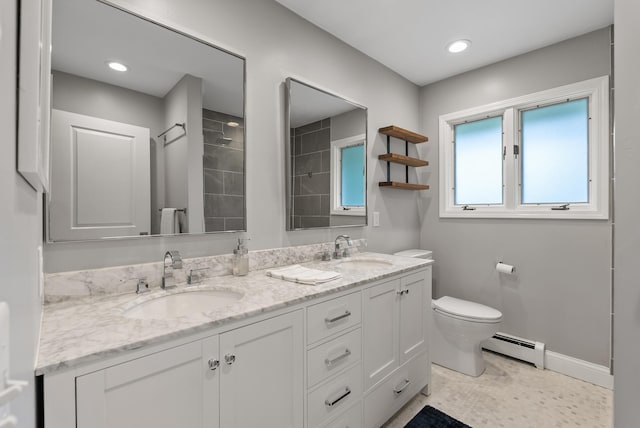8401 Meadow Lake Rd N, New Hope, MN 55428 - bathroom featuring baseboard heating, double vanity, toilet, tiled shower, and baseboards