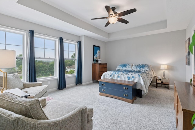 7465 Glengarry Pl, Eden Prairie, MN 55344 - bedroom featuring a tray ceiling, light carpet, and a ceiling fan