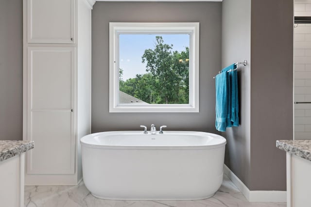 7465 Glengarry Pl, Eden Prairie, MN 55344 - full bathroom with marble look tile flooring, a freestanding tub, and vanity