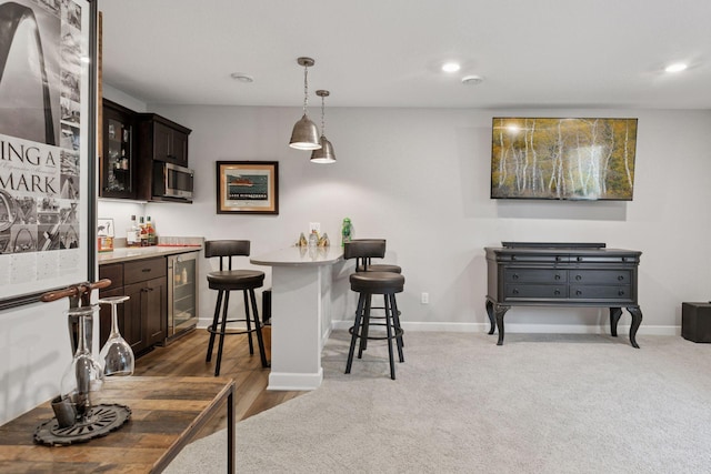7465 Glengarry Pl, Eden Prairie, MN 55344 - indoor dry bar featuring stainless steel microwave, beverage cooler, recessed lighting, and decorative light fixtures