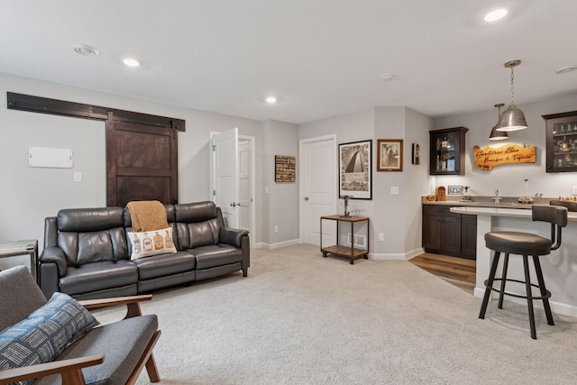 7465 Glengarry Pl, Eden Prairie, MN 55344 - living room featuring a barn door, light colored carpet, recessed lighting, and bar with sink