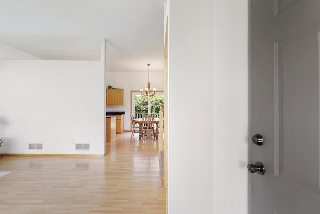 20736 196th Ave NW, Big Lake Twp, MN 55309 - corridor featuring light wood-style floors, a chandelier, and baseboards