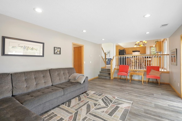 20736 196th Ave NW, Big Lake Twp, MN 55309 - living room with stairway, light wood-style flooring, recessed lighting, a chandelier, and baseboards