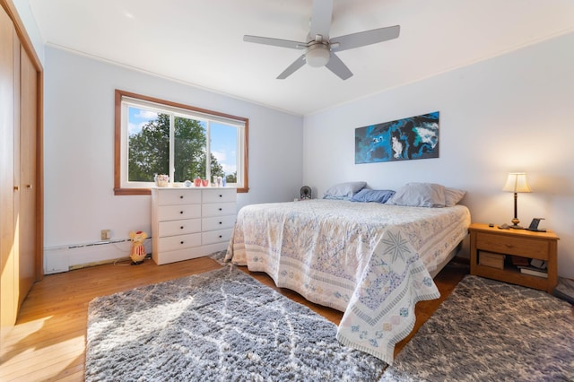 1928 Loop Rd, Two Harbors, MN 55616 - bedroom with wood finished floors, ceiling fan, and baseboard heating