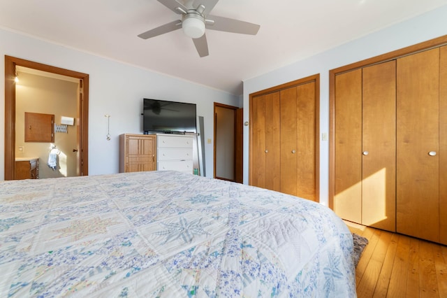 1928 Loop Rd, Two Harbors, MN 55616 - bedroom featuring two closets, light wood-style flooring, ceiling fan, and ornamental molding
