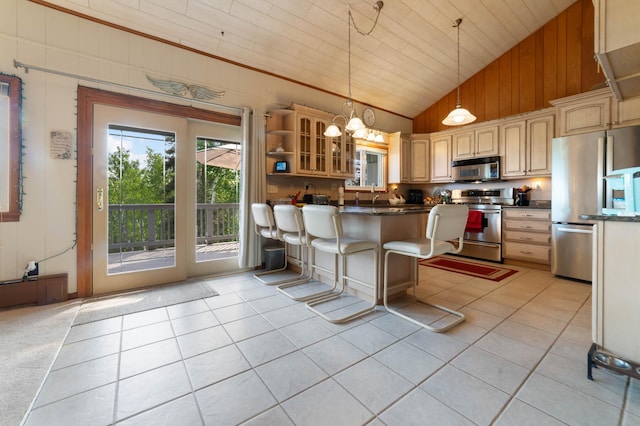 1928 Loop Rd, Two Harbors, MN 55616 - kitchen featuring freestanding refrigerator, stainless steel range oven, vaulted ceiling, light tile patterned floors, and dark countertops