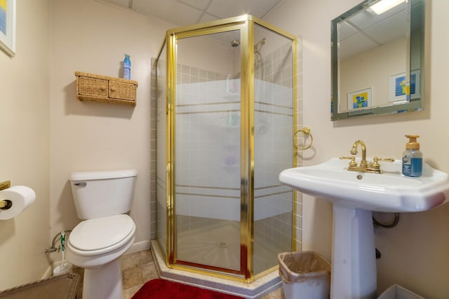 1928 Loop Rd, Two Harbors, MN 55616 - full bathroom with a paneled ceiling, toilet, a stall shower, and a sink
