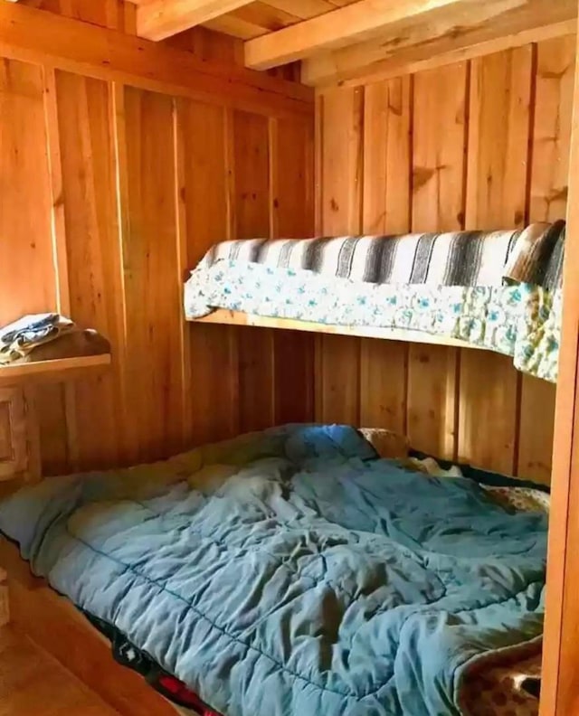 TBD Echo Trl, Greenwood Twp, MN 55771 - bedroom with wooden walls and beam ceiling