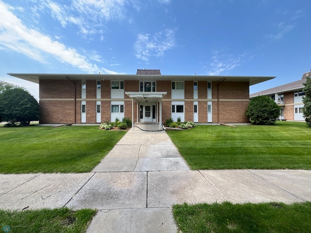 2711 12th St S Unit A2, Fargo, ND 58103 - view of front facade with brick siding and a front yard