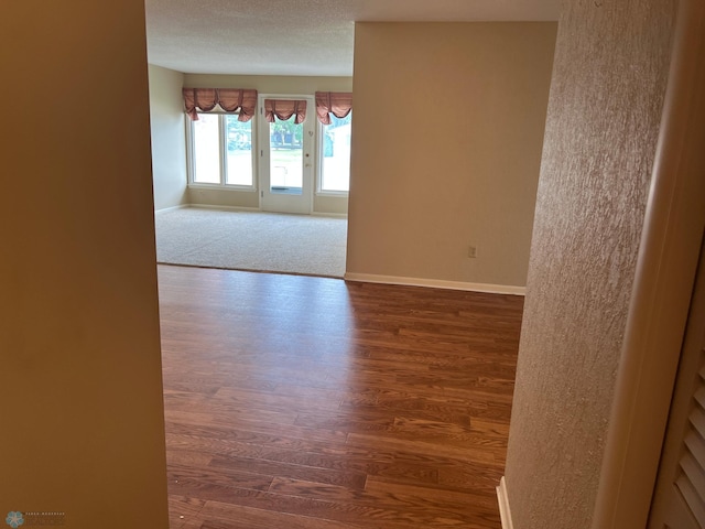 2711 12th St S Unit A2, Fargo, ND 58103 - spare room featuring wood finished floors and a textured ceiling