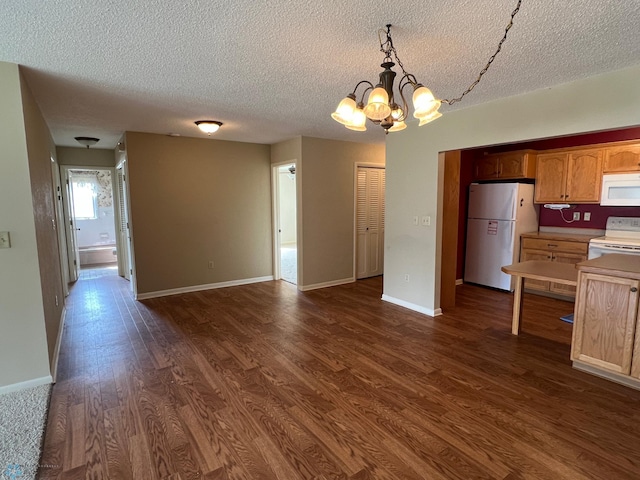 2711 12th St S Unit A2, Fargo, ND 58103 - kitchen featuring white appliances, a chandelier, dark wood finished floors, a textured ceiling, and light countertops
