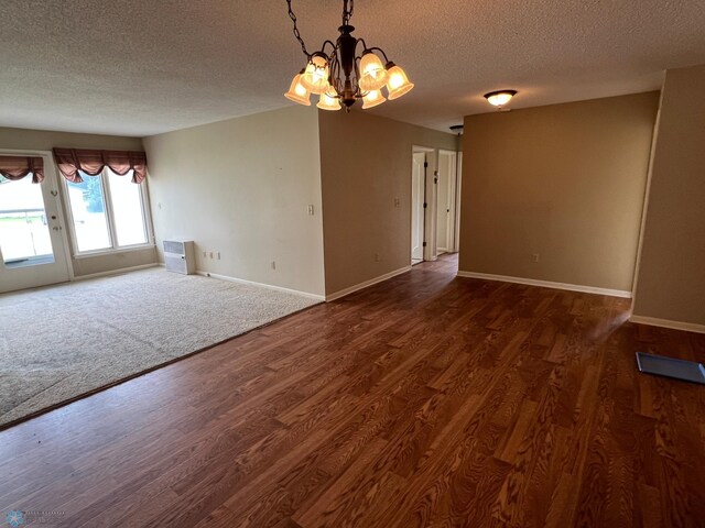 2711 12th St S Unit A2, Fargo, ND 58103 - spare room with a textured ceiling, a chandelier, and wood finished floors