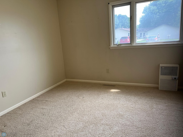 2711 12th St S Unit A2, Fargo, ND 58103 - carpeted spare room with baseboards and heating unit