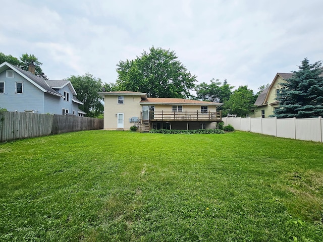 735 Main St N, Hutchinson, MN 55350 - rear view of property featuring a wooden deck and a fenced backyard