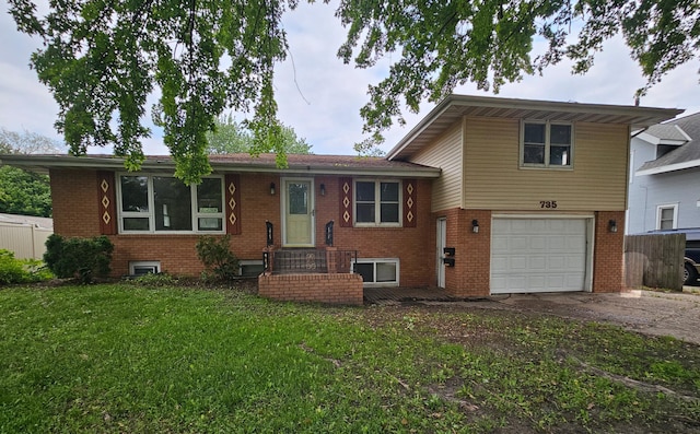 735 Main St N, Hutchinson, MN 55350 - split level home featuring driveway, an attached garage, brick siding, and a front lawn
