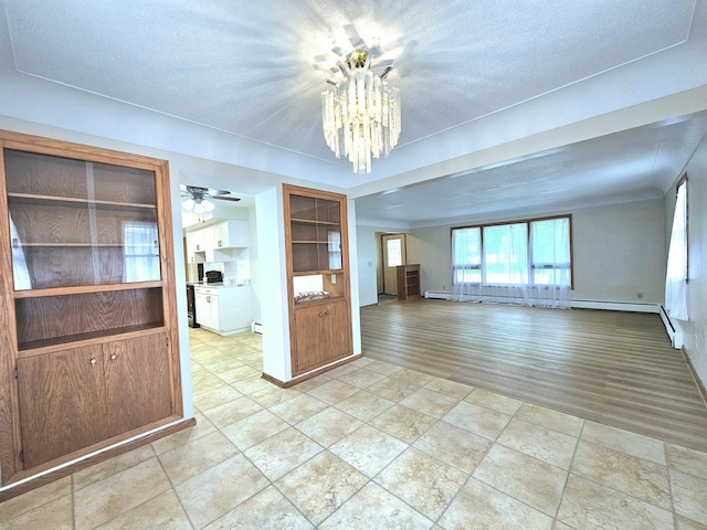 735 Main St N, Hutchinson, MN 55350 - unfurnished room featuring a chandelier and a textured ceiling
