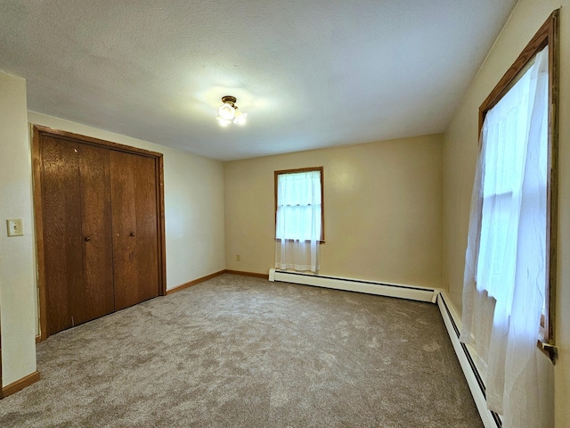 735 Main St N, Hutchinson, MN 55350 - unfurnished bedroom with a baseboard heating unit, carpet flooring, and a closet