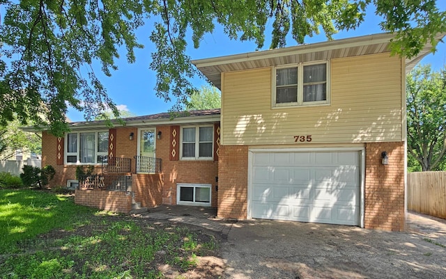 735 Main St N, Hutchinson, MN 55350 - split level home with an attached garage, brick siding, and asphalt driveway
