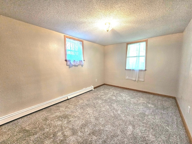 735 Main St N, Hutchinson, MN 55350 - carpeted empty room with a baseboard radiator, healthy amount of natural light, a textured ceiling, and a textured wall