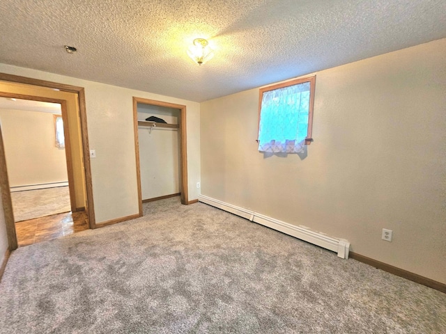 735 Main St N, Hutchinson, MN 55350 - unfurnished bedroom featuring a baseboard heating unit, a closet, carpet, and a textured ceiling