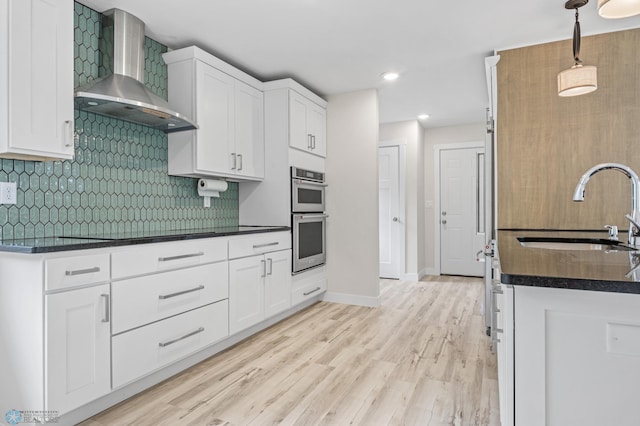 11763 230th St N, Keene Twp, MN 56549 - kitchen with wall chimney exhaust hood, double oven, a sink, dark countertops, and white cabinets