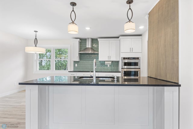 11763 230th St N, Keene Twp, MN 56549 - kitchen featuring wall chimney exhaust hood, a sink, double oven, white cabinets, and dark stone countertops