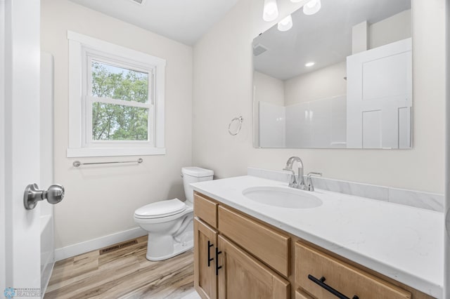 11763 230th St N, Keene Twp, MN 56549 - full bathroom with vanity, baseboards, toilet, wood finished floors, and a shower