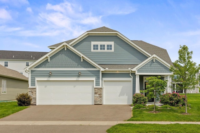14645 Cloquet St, Dayton, MN 55327 - craftsman-style house featuring asphalt driveway, a front lawn, a shingled roof, stone siding, and a garage