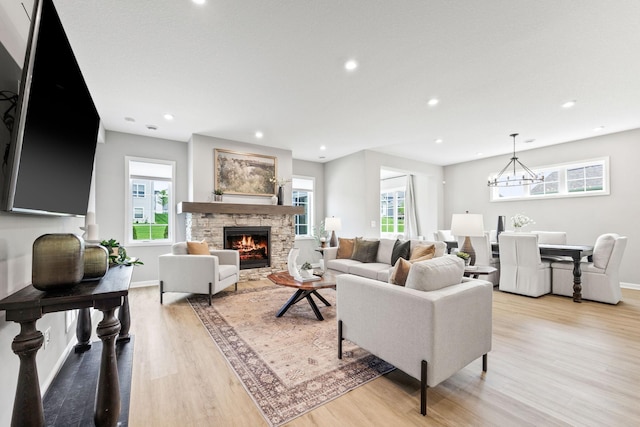 14645 Cloquet St, Dayton, MN 55327 - living area with light wood-style floors, plenty of natural light, recessed lighting, a fireplace, and a chandelier