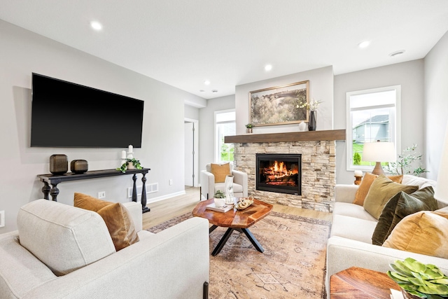 14645 Cloquet St, Dayton, MN 55327 - living room featuring light wood finished floors, a stone fireplace, and recessed lighting