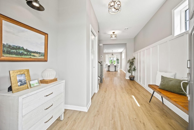 14645 Cloquet St, Dayton, MN 55327 - hallway with light wood-style floors and a chandelier