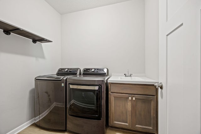 14645 Cloquet St, Dayton, MN 55327 - laundry room with washer and clothes dryer, cabinet space, and light wood-type flooring