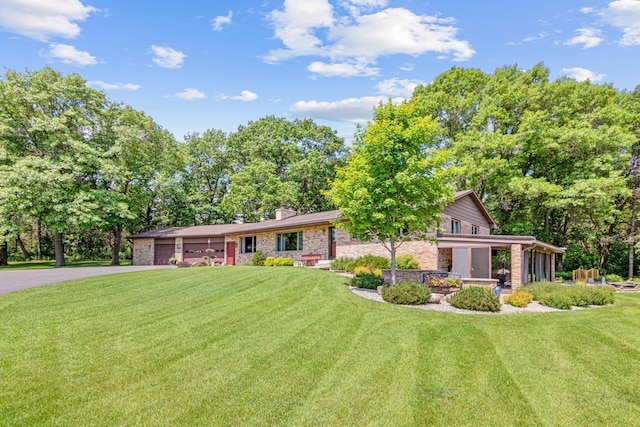 17000 Jackal St NW, Ramsey, MN 55303 - view of front of property featuring driveway, an attached garage, a front yard, and brick siding