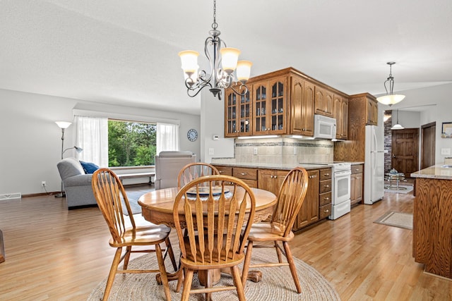 17000 Jackal St NW, Ramsey, MN 55303 - dining space featuring light wood-type flooring and a chandelier