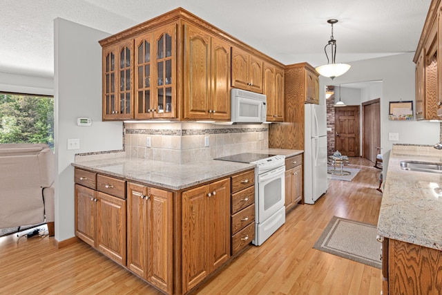 17000 Jackal St NW, Ramsey, MN 55303 - kitchen with white appliances, light wood-type flooring, brown cabinets, decorative backsplash, and glass insert cabinets