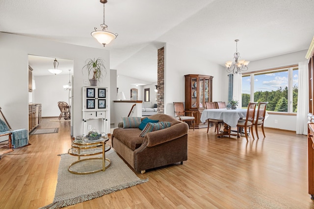 17000 Jackal St NW, Ramsey, MN 55303 - living room with a chandelier, light wood-style floors, and lofted ceiling