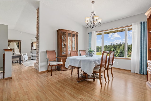 17000 Jackal St NW, Ramsey, MN 55303 - dining space featuring vaulted ceiling, light wood-type flooring, and a chandelier