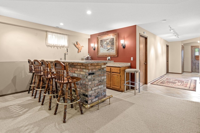 17000 Jackal St NW, Ramsey, MN 55303 - indoor wet bar featuring plenty of natural light, recessed lighting, light carpet, and track lighting