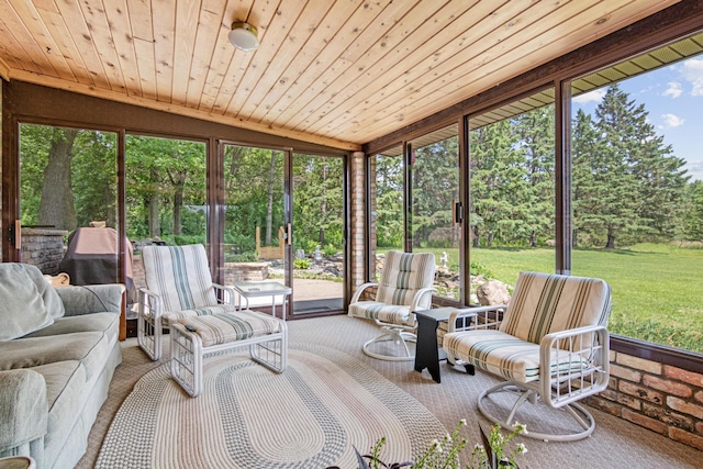 17000 Jackal St NW, Ramsey, MN 55303 - sunroom / solarium featuring an outdoor hangout area, lofted ceiling, and view of wooded area