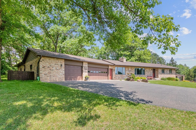 17000 Jackal St NW, Ramsey, MN 55303 - ranch-style home featuring a garage, driveway, brick siding, and a chimney