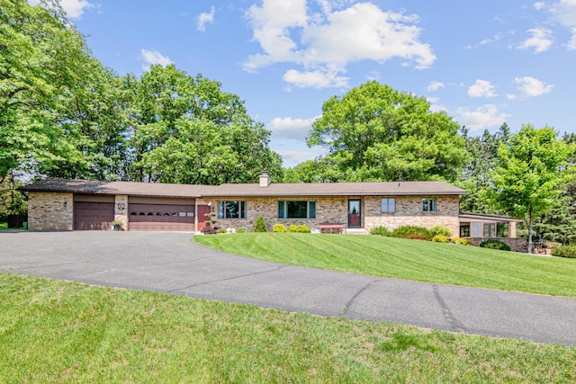17000 Jackal St NW, Ramsey, MN 55303 - ranch-style house with a garage, a front lawn, driveway, brick siding, and a chimney