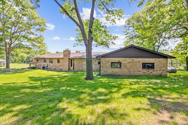17000 Jackal St NW, Ramsey, MN 55303 - back of property featuring brick siding, a chimney, and a yard