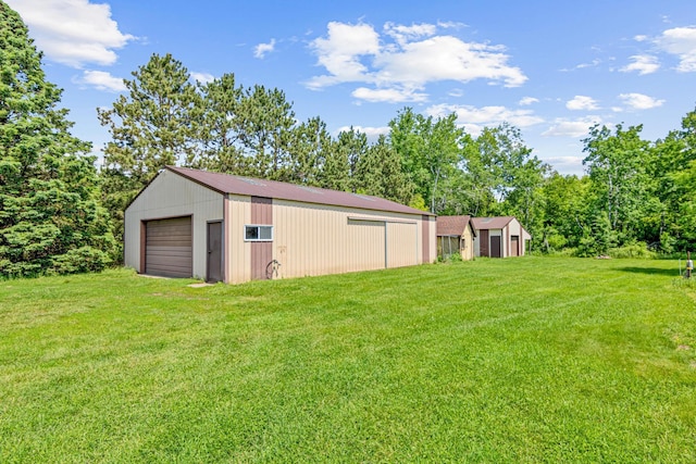 17000 Jackal St NW, Ramsey, MN 55303 - view of grassy yard with an outdoor structure, a detached garage, and a pole building