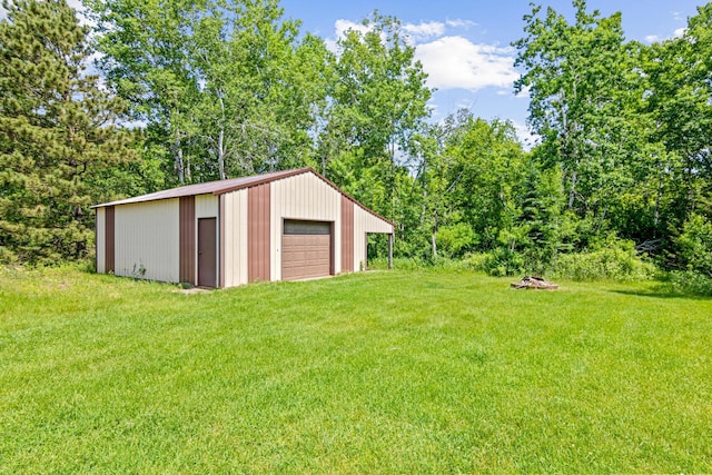 17000 Jackal St NW, Ramsey, MN 55303 - view of green lawn featuring a garage, an outdoor structure, and driveway