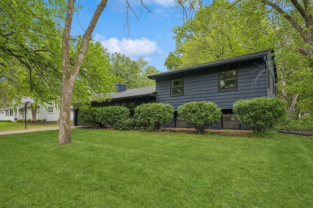 2500 Ensign Ave N, Golden Valley, MN 55427 - view of side of home featuring a lawn and a chimney