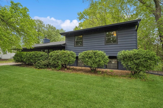 2500 Ensign Ave N, Golden Valley, MN 55427 - view of property exterior featuring a yard and a chimney