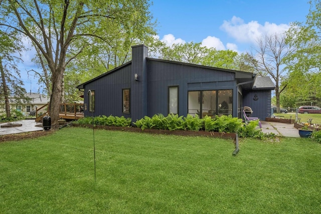 2500 Ensign Ave N, Golden Valley, MN 55427 - back of property featuring a deck and a chimney