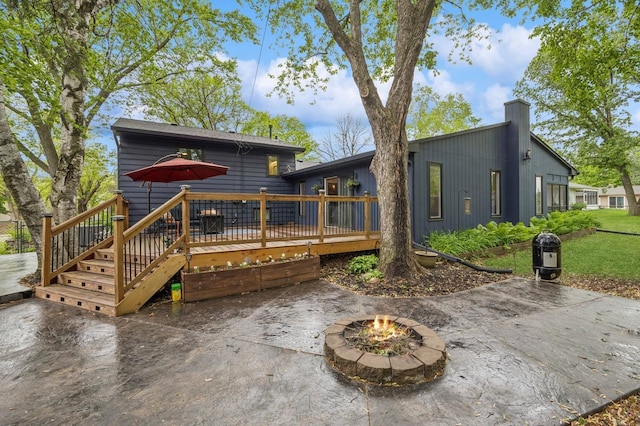2500 Ensign Ave N, Golden Valley, MN 55427 - back of house featuring a wooden deck, a patio, a fire pit, and a chimney