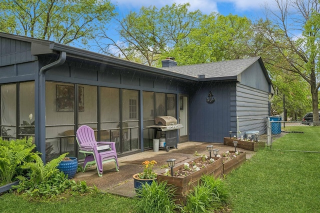 2500 Ensign Ave N, Golden Valley, MN 55427 - rear view of property featuring a garden, a chimney, and a sunroom