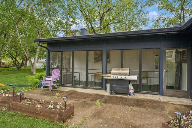 2500 Ensign Ave N, Golden Valley, MN 55427 - rear view of property with a sunroom, a garden, a yard, a chimney, and a patio area